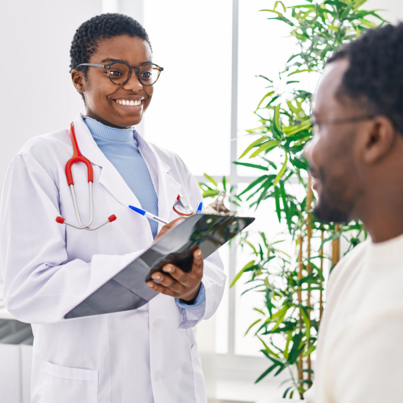 Man and woman doctor and patient having medical consultation speaking at clinic